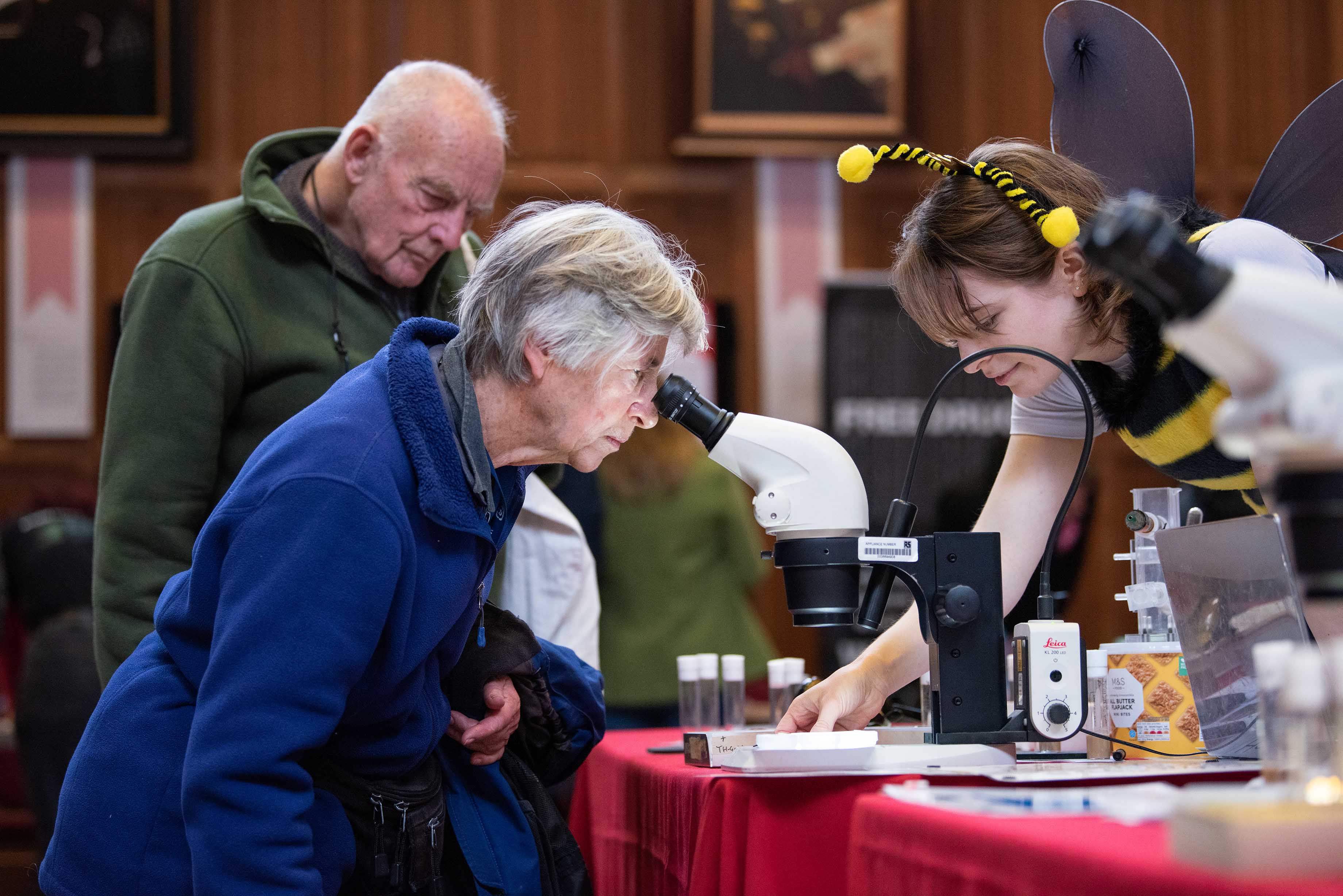 A member of the public looking through a microscope